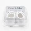 New Baby Kojenecké capáčky s mašličkou bílá 0-3 m